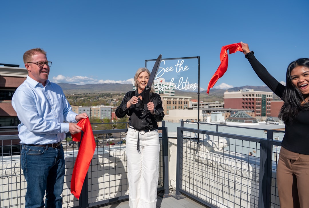 Business coach Allison Dunn cuts the ribbon during the Deliberate Directions open house, symbolizing a new chapter for the firm’s downtown Boise space. Flanked by Business Optimization Coach Bryant Jones and Client Success Coordinator Arianna Mangubat, the moment captures energy, celebration, and the community behind the brand’s mission. The sign behind them reads See the Possibilities, underscoring themes of vision, leadership, and transformation.